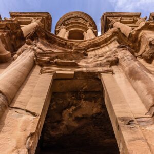 Low angle exterior view of the rock-cut architecture of El Deir or The Monastery at Petra, Jordan.